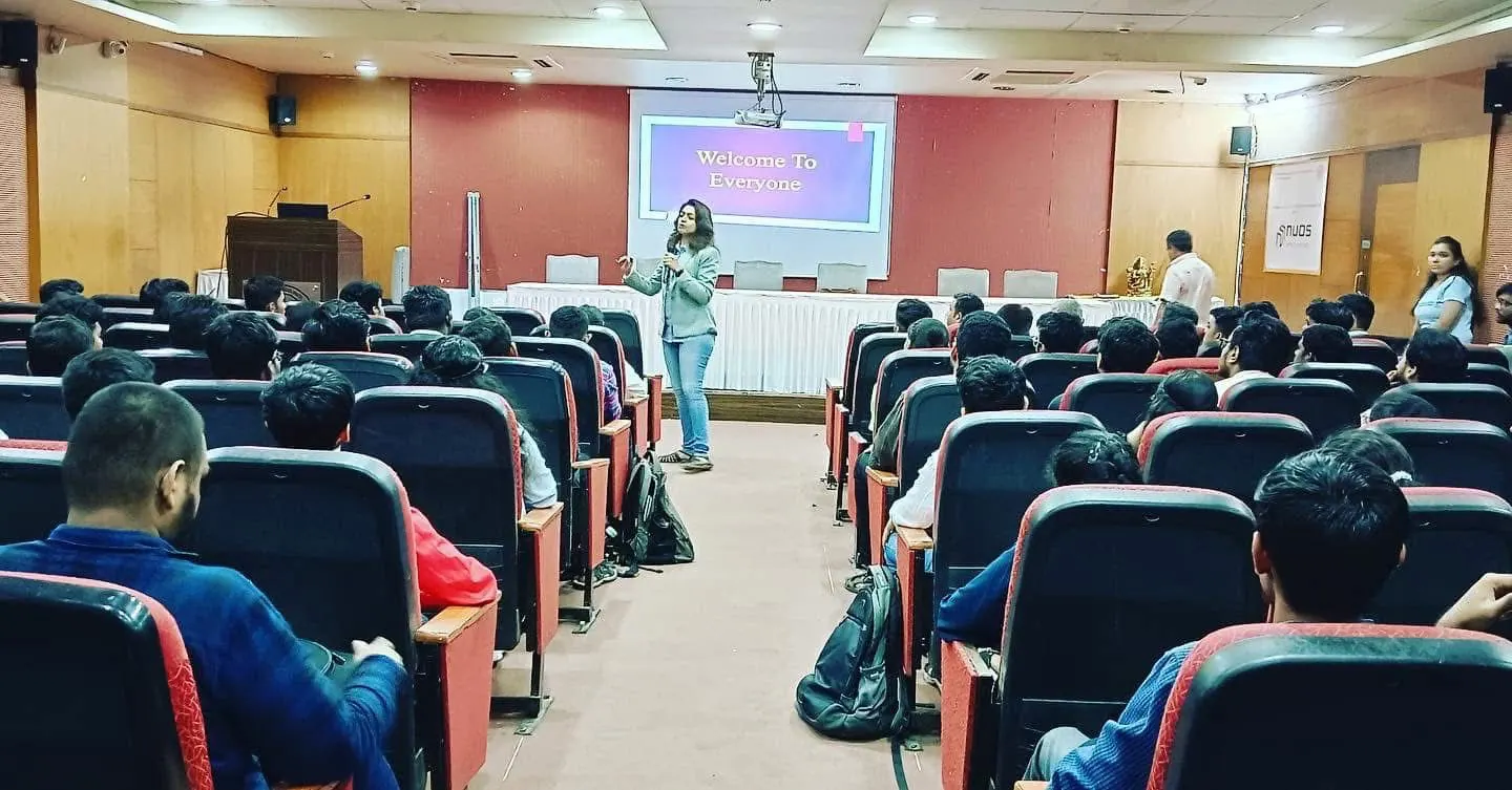 Sayali teaching learners in an auditorium